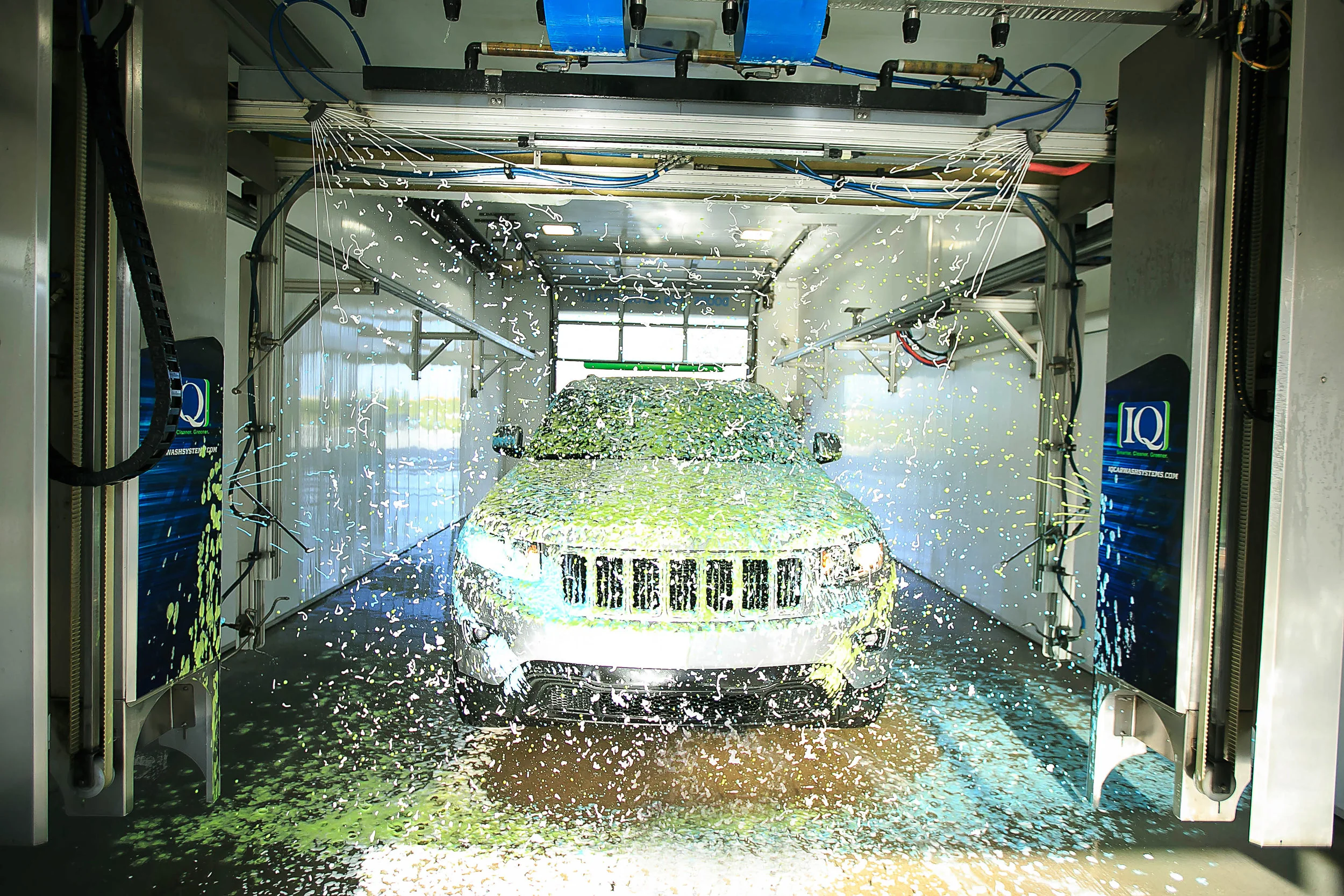 Touch-free in-bay automatic car wash at iQ Car Wash using CarWashSoap.com automatic car wash chemicals